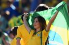 SAO PAULO, BRAZIL - JUNE 12:  A Brazil fan waves the Brazilian flag before the Opening Ceremony of the 2014 FIFA World Cup Brazil prior to the Group A match between Brazil and Croatia at Arena de Sao Paulo on June 12, 2014 in Sao Paulo, Brazil.  (Photo by Adam Pretty/Getty Images)
