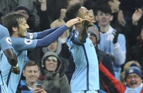 Manchester City's Raheem Sterling, right, celebrates after scoring during the English Premier League soccer match between Manchester City and Arsenal at the Etihad Stadium in Manchester, England, Sunday, Dec. 18, 2016. (AP Photo/Rui Vieira)