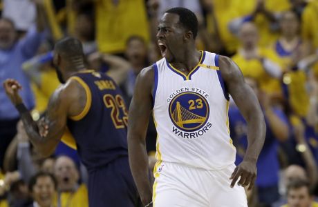 Golden State Warriors forward Draymond Green, foreground, reacts in front of Cleveland Cavaliers forward LeBron James during the second half of Game 1 of basketball's NBA Finals in Oakland, Calif., Thursday, June 1, 2017. (AP Photo/Marcio Jose Sanchez)
