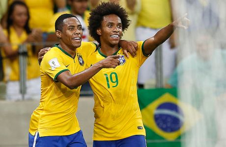 Brazil's Willian, right, celebrates with teammate Elias after scoring against Venezuela during a 2018 World Cup qualifying soccer match in Fortaleza, Brazil, Tuesday, Oct. 13, 2015. (AP Photo/Andre Penner)