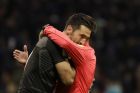 Referee Antonio Mateu Lahoz of Spain hugs Italy goalkeeper Gianluigi Buffon at the end of the first half during the World Cup qualifying play-off second leg soccer match between Italy and Sweden, at the Milan San Siro stadium, Italy, Monday, Nov. 13, 2017. (AP Photo/Luca Bruno)