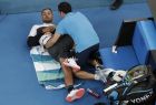 Australia's Nick Kyrgios receives treatment from a trainer during his first round match against Canada's Milos Raonic at the Australian Open tennis championships in Melbourne, Australia, Tuesday, Jan. 15, 2019. (AP Photo/Aaron Favila)