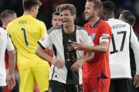 Germany's Thomas Muller laughs with England's Harry Kane at the end of the UEFA Nations League soccer match between England and Germany at Wembley stadium in London, Monday, Sept. 26, 2022. (AP Photo/Kirsty Wigglesworth)