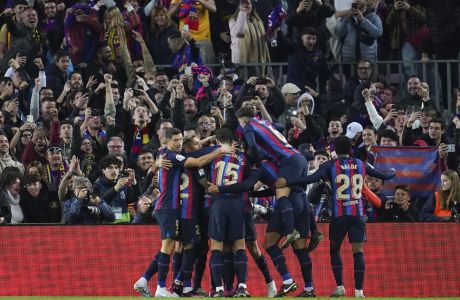 Barcelona players celebrate after their first goal during the Spanish La Liga soccer match between Barcelona and Real Madrid at Camp Nou stadium in Barcelona, Spain, Sunday, March 19, 2023. (AP Photo/Joan Mateu)