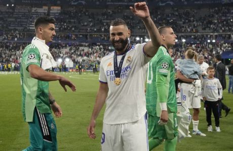 Real Madrid's Karim Benzema applauds fans after winning the Champions League final soccer match between Liverpool and Real Madrid at the Stade de France in Saint Denis near Paris, Sunday, May 29, 2022. (AP Photo/Kirsty Wigglesworth)