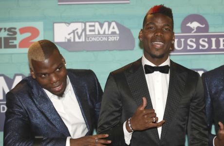FILE - Soccer players Mathias Pogba, left, Paul Pogba pose for photographers upon arrival at the MTV European Music Awards 2017 in London, Sunday, Nov. 12, 2017. A police investigation into allegations that France soccer star Paul Pogba was targeted by extortionists took a bizarre new twist Friday Sept. 23, 2022 with the release by one of the suspects, his elder brother Mathias, of a long string of videos taking aim at the 2018 World Cup winner, his entourage and wealthy lifestyle. (Photo by Vianney Le Caer/Invision/AP, File)