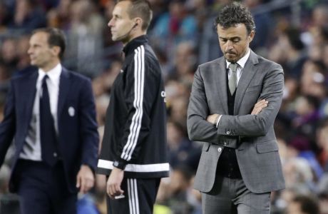 Barcelona's head coach Luis Enrique and Juventus head coach Massimiliano Allegri, left, stand on the sideline during the Champions League quarterfinal second leg soccer match between Barcelona and Juventus at Camp Nou stadium in Barcelona, Spain, Wednesday, April 19, 2017. (AP Photo/Emilio Morenatti)