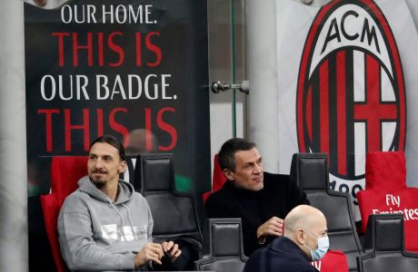 AC Milan forward Zlatan Ibrahimovic, left, and former Milan player Milan player Paolo Maldini sit on the bench before the Serie A soccer match between AC Milan and Udinese at the San Siro stadium, in Milan, Italy, Wednesday, March 3, 2021. (AP Photo/Antonio Calanni)