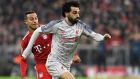Liverpool forward Mohamed Salah, right, duels for the ball with Bayern midfielder Thiago Alcantara during the Champions League round of 16 second leg soccer match between Bayern Munich and Liverpool at the Allianz Arena, in Munich, Germany, Wednesday, March 13, 2019. (AP Photo/Kerstin Joensson)