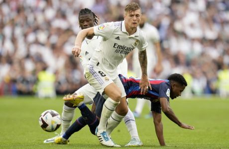 Barcelona's Ansu Fati, right, loses the ball to Real Madrid's Toni Kroos during a Spanish La Liga soccer match between Real Madrid and Barcelona at the Santiago Bernabeu stadium in Madrid, Sunday, Oct. 16, 2022. (AP Photo/Manu Fernandez)