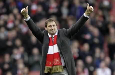 Former Arsenal's player Tony Adams reacts as he is being presented to the fans before the start of English Premier League soccer match between Arsenal and Queens Park Rangers at Emirates Stadium, London, Saturday, Dec. 31, 2011. (AP Photo/Sang Tan)