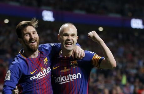 Barcelona's Andres Iniesta, right, celebrates withLionel Messi after scoring his side's fourth goal during the Copa del Rey final soccer match between Barcelona and Sevilla at the Wanda Metropolitano stadium in Madrid, Spain, Saturday, April 21, 2018. (AP Photo/Paul White)