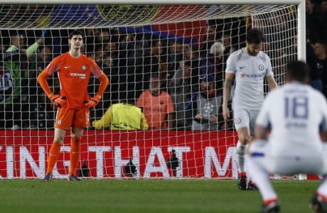 Chelsea goalkeeper Thibaut Courtois, left, reacts after Barcelona's Lionel Messi scored his side's third goal during the Champions League round of sixteen second leg soccer match between FC Barcelona and Chelsea at the Camp Nou stadium in Barcelona, Spain, Wednesday, March 14, 2018. (AP Photo/Manu Fernandez)