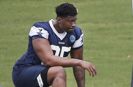 Dallas Cowboys defensive tackle David Irving (95) stretches during practice at the NFL football team's training camp in Frisco, Texas, Tuesday, June 12, 2018. (AP Photo/Brandon Wade)