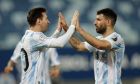 FILE - Argentina's Lionel Messi, left, celebrates scoring his side's second goal from the penalty spot with teammate Sergio Aguero during a Copa America soccer match against Bolivia at Arena Pantanal stadium in Cuiaba, Brazil, June 28, 2021. Barcelona striker Sergio Aguero has on Wednesday, Dec. 15 announced his immediate retirement for health reasons. (AP Photo/Bruna Prado, file)