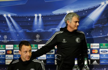 Chelsea's manager Jose Mourinho, right, puts his hand on the shoulder of player John Terry during a press conference at Stamford Bridge stadium in London, Tuesday, April 29, 2014. Chelsea will play in a Champions League semifinal second leg soccer match against Atletico Madrid on Wednesday. (AP Photo/Kirsty Wigglesworth) 