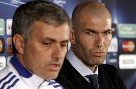 Special adviser to Real Madrid's first team Zinedine Zidane, right, looks on as Real Madrid's coach Jose Mourinho, left, talks during a press conference in Lyon, central France, Monday, Feb. 21, 2011. Real Madrid will face Lyon in a Champions League soccer match on Tuesday. (AP Photo/Laurent Cipriani)