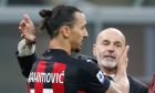 FILE - In this Saturday, Oc.t 17, 2020 file photo, AC Milan manager Stefano Pioli, right, congratulates Zlatan Ibrahimovic at the end of the Serie A soccer match between Inter Milan and AC Milan at the San Siro Stadium, in Milan, Italy. AC Milan coach Stefano Pioli has recovered from the coronavirus and will be back on the sidelines for Thursdays Europa League match against Celtic. Milan said on Wednesday that the latest tests carried out on Pioli and his assistant Giacomo Murelli were negative for COVID-19. (AP Photo/Antonio Calanni, File)