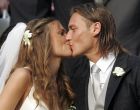 FILE - In this  June 19, 2005 file photo, Roma's captain Francesco Totti kisses his bride showgirl Ilary Blasi outside the Roman church of Santa Maria in Ara Coeli after their wedding. Totti celebrates his 40th birthday on Tuesday, Sept. 27, 2016,  but is showing no signs of slowing down and indeed seems to have found a new lease of life. He may not be Roma's 'Golden Boy' anymore but he is still very much 'the King of Rome.' (AP Photo/Plinio Lepri)