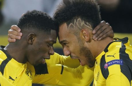 Dortmund's Ousmane Dembele, left, congratulates Dortmund's Pierre-Emerick Aubameyang as they celebrate after scoring the opening goal during the Champions League round of 16, second leg, soccer match between Borussia Dortmund and Benfica in Dortmund, Germany, Wednesday, March 8, 2017. (AP Photo/Michael Probst)