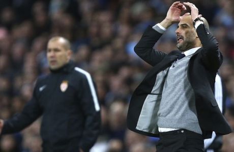 Manchester City's manager Pep Guardiola, right, and Monaco's head coach Leonardo Jardim react during the Champions League round of 16 first leg soccer match between Manchester City and Monaco at the Etihad Stadium in Manchester, England, Tuesday Feb. 21, 2017. (AP Photo/Dave Thompson)