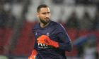 PSG's goalkeeper Gianluigi Donnarumma runs out to warm-up before the French League One soccer match between Paris Saint-Germain and Lyon at the Parc des Princes in Paris Sunday, Sept. 19, 2021. (AP Photo/Francois Mori)