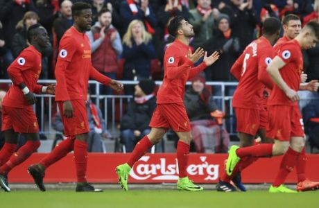 Liverpool's Emre Can, center, celebrates scoring his side's second goal during the English Premier League soccer match between Liverpool and Burnley at Anfield, Liverpool, England, Sunday, March 12, 2017. (Peter Byrne/PA via AP)
