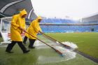 NATAL, BRAZIL - JUNE 13: Stadium workers sweep rain water off the field toward a drain before the 2014 FIFA World Cup Brazil Group A match between Mexico and Cameroon at Estadio das Dunas on June 13, 2014 in Natal, Brazil.  (Photo by Julian Finney/Getty Images)