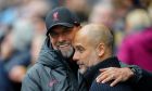Liverpool's manager Jurgen Klopp, left, greets Manchester City's head coach Pep Guardiola prior to the English Premier League soccer match between Manchester City and Liverpool at Etihad stadium in Manchester, England, Saturday, April 1, 2023. (AP Photo/Jon Super)