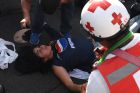 Members of the Red Cross assist an injured supporter of Honduran team Motagua after a stampede at the National Stadium in Tegucigalpa on May 28, 2017.
At least two people were killed and 25 injured in the chaos and unrest caused when hundreds of fans tried to enter the overcrowded stadium before the final match of the Clausura football tournament between Motagua and Honduras Progreso. / AFP PHOTO / ORLANDO SIERRA        (Photo credit should read ORLANDO SIERRA/AFP/Getty Images)