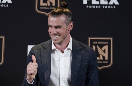 FILE - Gareth Bale gives a thumbs-up as he is introduced as a new member of the Los Angeles FC MLS soccer club Monday, July 11, 2022, in Los Angeles.  Gareth Bale feels fitter and happier since joining MLS team Los Angeles FC and is hoping that helps his performances for Wales going into the World Cup. Bale chose to move to the United States to get the most out of the final years of his career for club and country after some tough times at Real Madrid. (AP Photo/Marcio Jose Sanchez, File)
