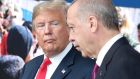 FILE - In this July 11, 2018 file photo, President Donald Trump, left, talks to Turkish President Recep Tayyip Erdogan as they tour the new NATO headquarters in Brussels, Belgium.  Trumps decision to withdraw American troops from Syria was made hastily, without consulting his national security team or allies, and over the strong objections of virtually everyone involved in the fight against the Islamic State, according to U.S. officials. Trump stunned his Cabinet, lawmakers and much of the world with the move that triggered Defense Secretary Jim Mattis resignation by rejecting the advice of his top aides and agreeing to the pull-out in a phone call with Turkish President Recep Tayyip Erdogan last week, two officials briefed on the matter said. (Tatyana Zenkovich/pool photo via AP)