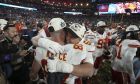 Kansas City Chiefs tight end Travis Kelce, (87) and defensive end George Karlaftis (56) hug after winning the NFL Super Bowl 57 football game, Sunday, Feb. 12, 2023, in Glendale, Ariz. (AP Photo/Doug Benc)