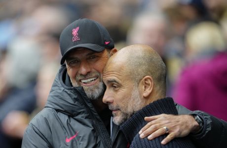 Liverpool's manager Jurgen Klopp, left, greets Manchester City's head coach Pep Guardiola prior to the English Premier League soccer match between Manchester City and Liverpool at Etihad stadium in Manchester, England, Saturday, April 1, 2023. (AP Photo/Jon Super)