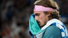 Greece's Stefanos Tsitsipas wipes sweat from his face during a break in his fourth round match against Switzerland's Roger Federer at the Australian Open tennis championships in Melbourne, Australia, Sunday, Jan. 20, 2019. (AP Photo/Andy Brownbill)
