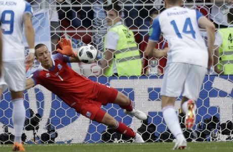 Iceland goalkeeper Hannes Halldorsson saves a penalty by Argentina's Lionel Messi during the group D match between Argentina and Iceland at the 2018 soccer World Cup in the Spartak Stadium in Moscow, Russia, Saturday, June 16, 2018. (AP Photo/Matthias Schrader)