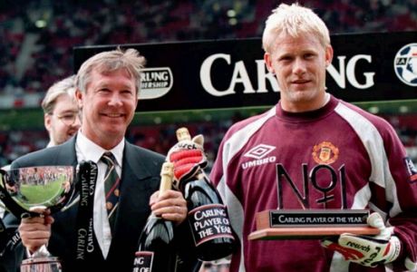 Manchester United manager Alex Ferguson, left, and 'keeper Peter Schmeichel collect the Manager of the Year award and the Player of the Year award respectively before the kick off of their English FA Premiership game against Blackburn Rovers Sunday August 25 1996 which ended in a 2-2 draw. (AP Photo/ Dave Kendall)