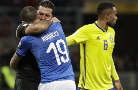 Sweden's Isaac Thelin comforts a crying Italy goalkeeper Gianluigi Buffon who is hugging Italy's Andrea Belotti after their elimination in the World Cup qualifying play-off second leg soccer match between Italy and Sweden, at the Milan San Siro stadium, Italy, Monday, Nov. 13, 2017. (AP Photo/Luca Bruno)