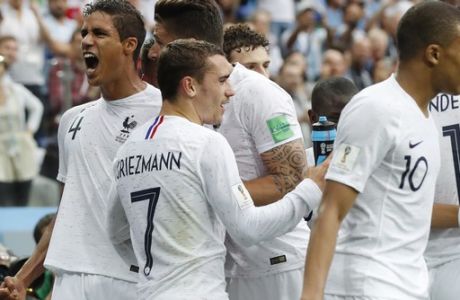 France's Raphael Varane, left, celebrate with teammates after scoring his side's first goal during the quarterfinal match between Uruguay and France at the 2018 soccer World Cup in the Nizhny Novgorod Stadium, in Nizhny Novgorod, Russia, Friday, July 6, 2018. (AP Photo/Petr David Josek)