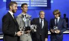 Real Madrid 's Sergio Ramos "Defender of the saison 2016-2017", left, Real Madrid's Cristiano Ronaldo of Portugal "Forward of the saison 2016-2017", second left, Real Madrid's Luka Modric, right, "Midfielder of the saison 2016-2017", hold their trophies , as they pose with Real Madrid's president Florentino Perez, after the UEFA Champions League draw, at the Grimaldi Forum, in Monaco, Thursday, Aug. 24, 2017. (AP Photo/Claude Paris)