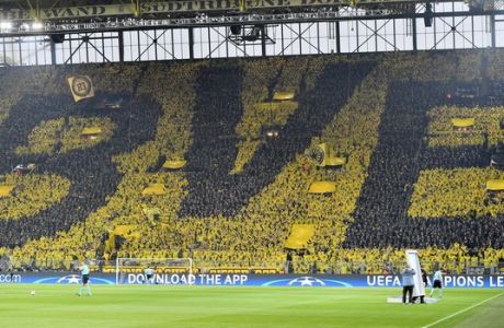 Dortmund fans form the letters of their team prior to the Champions League quarterfinal first leg soccer match between Borussia Dortmund and AS Monaco in Dortmund, Germany, Wednesday, April 12, 2017. (AP Photo/Martin Meissner)
