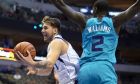 Dallas Mavericks' Luka Doncic (77) drives to the basket against Charlotte Hornets' Marvin Williams (2) during the first half of an NBA preseason basketball game Friday, Oct. 12, 2018, in Dallas. (AP Photo/Cooper Neill)