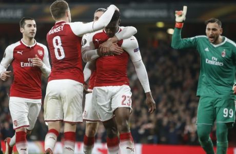 Arsenal's Danny Welbeck celebrates with his teammate Aaron Ramsey, left, after scoring his side opening goal on a penalty, as AC Milan goalkeeper Gianluigi Donnarumma gestures, during the Europa League round of 16 second leg soccer match between Arsenal and AC Milan at the Emirates stadium in London, Thursday, March, 15, 2018. (AP Photo/Alastair Grant)