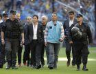 River Plate coach Marcelo Gallardo, second left, is escorted into the pitch during a local tournament soccer match against Boca Juniors in Buenos Aires, Argentina, Sunday, Sept. 23, 2018. (AP Photo/Natacha Pisarenko)