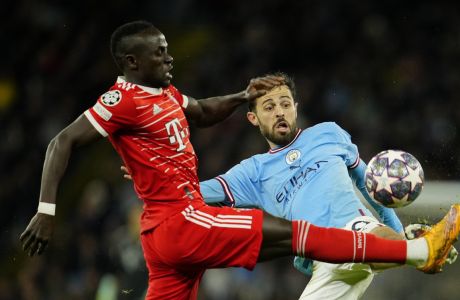 Bayern's Sadio Mane, left, fights for the ball with Manchester City's Bernardo Silva during the Champions League quarterfinal, first leg, soccer match between Manchester City and Bayern Munich at the Etihad stadium in Manchester, England, Tuesday, April 11, 2023. (AP Photo/Jon Super)