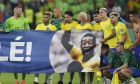 Brazil's players shows a banner in support of Brazilian soccer legend Pele at the end of the World Cup round of 16 soccer match between Brazil and South Korea, at the Stadium 974 in Doha, Qatar, Monday, Dec. 5, 2022. (AP Photo/Andre Penner)