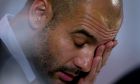 Bayern's head coach Pep Guardiola wipes his face during a press conference in Manchester, England, Monday, Nov. 24, 2014. Bayern Munich will play Manchester City on Tuesday in a Champions League Group E soccer match. (AP Photo/Jon Super)