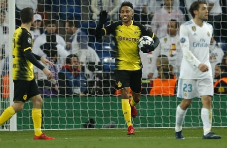 Dortmund's Pierre-Emerick Aubameyang, center, celebrates after scoring his side's first goal during the Champions League Group H soccer match between Real Madrid and Borussia Dortmund at the Santiago Bernabeu stadium in Madrid, Spain, Wednesday, Dec. 6, 2017. (AP Photo/Paul White)