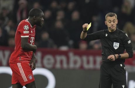 Bayern's Dayot Upamecano is shown a yellow card during the Champions League quarter final second leg soccer match between Bayern Munich and Manchester City, at the Allianz Arena stadium in Munich, Germany, Wednesday, April 19, 2023. (AP Photo/Matthias Schrader)