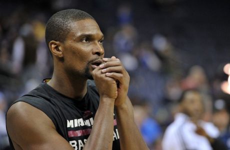 DEC. 7, 2014, FILE PHOTO FILE - In this Dec. 7, 2014, file photo, Miami Heat center Chris Bosh warms up before an NBA basketball game against the Memphis Grizzlies in Memphis, Tenn. Bosh underwent testing at a hospital Thursday, Feb. 19, 2015, to assess a medical issue related to the area around his lungs, a person with knowledge of the situation told The Associated Press. Bosh and the team were expecting to have a better grasp of the situation Friday, said the person, who spoke on condition of anonymity because neither the player nor the team had disclosed any specifics publicly. (AP Photo/Brandon Dill, File)